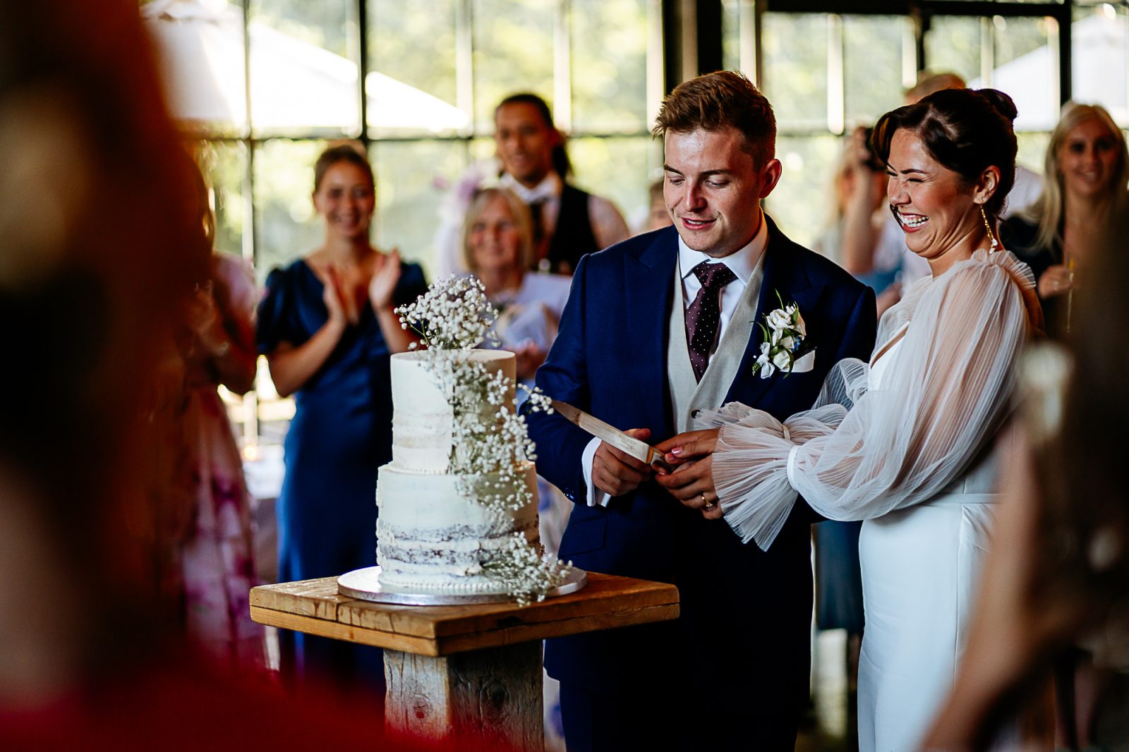 bride and groom cutting cake at hidden river barn