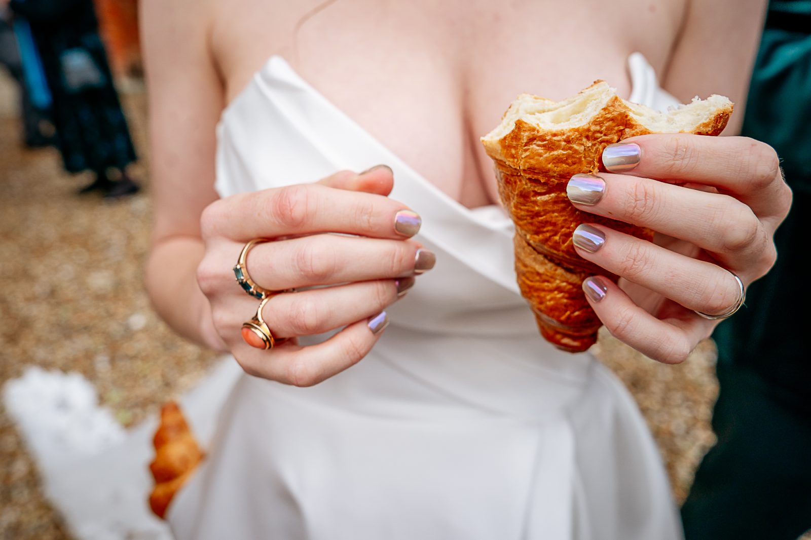 Bride holding croissant Farnham Castle