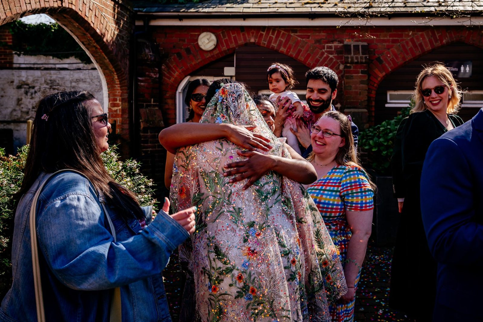 hug with bride captured by Documentary wedding photographer