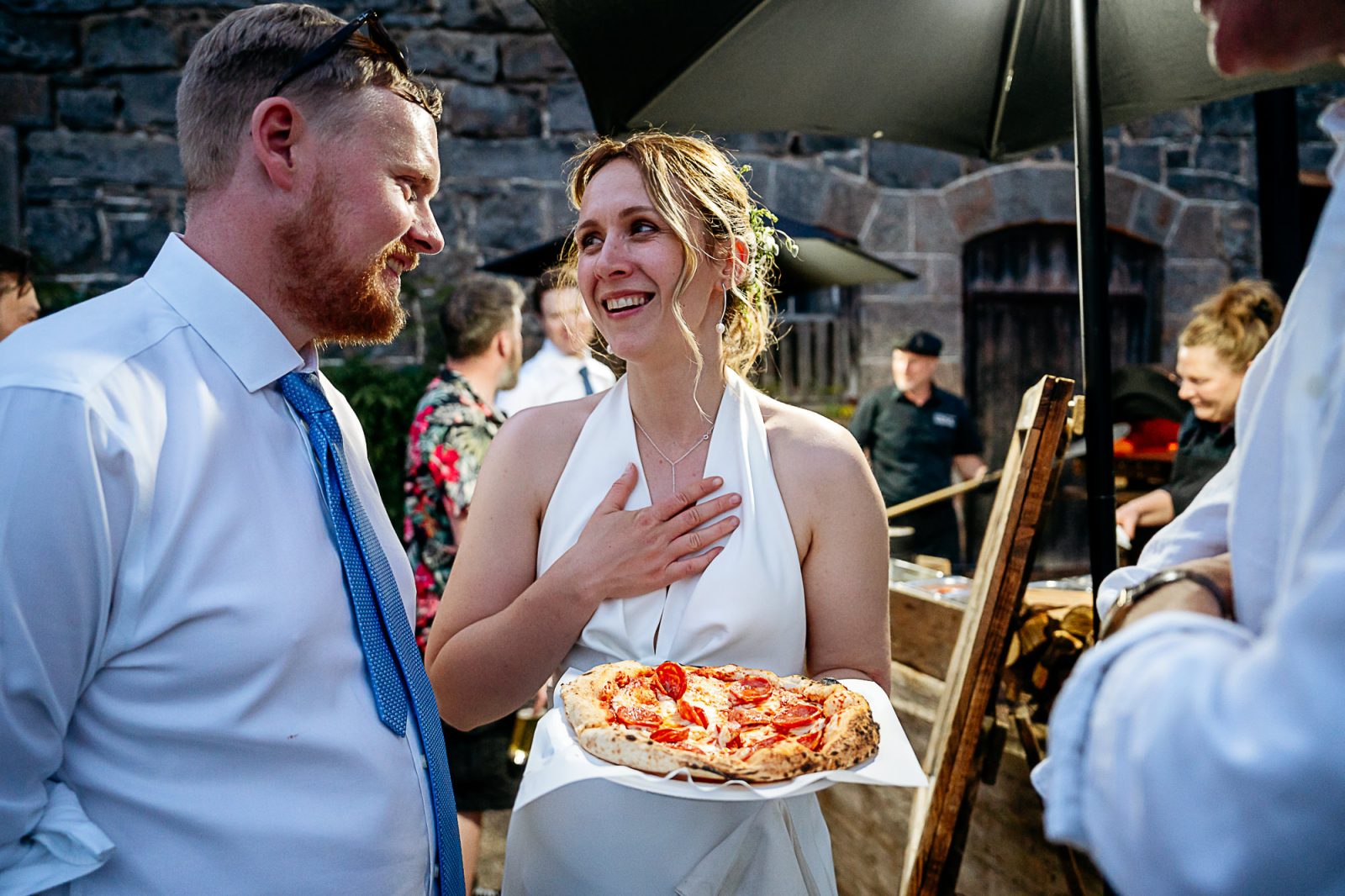 Bride eating pizza+ Shropshire wedding photographers